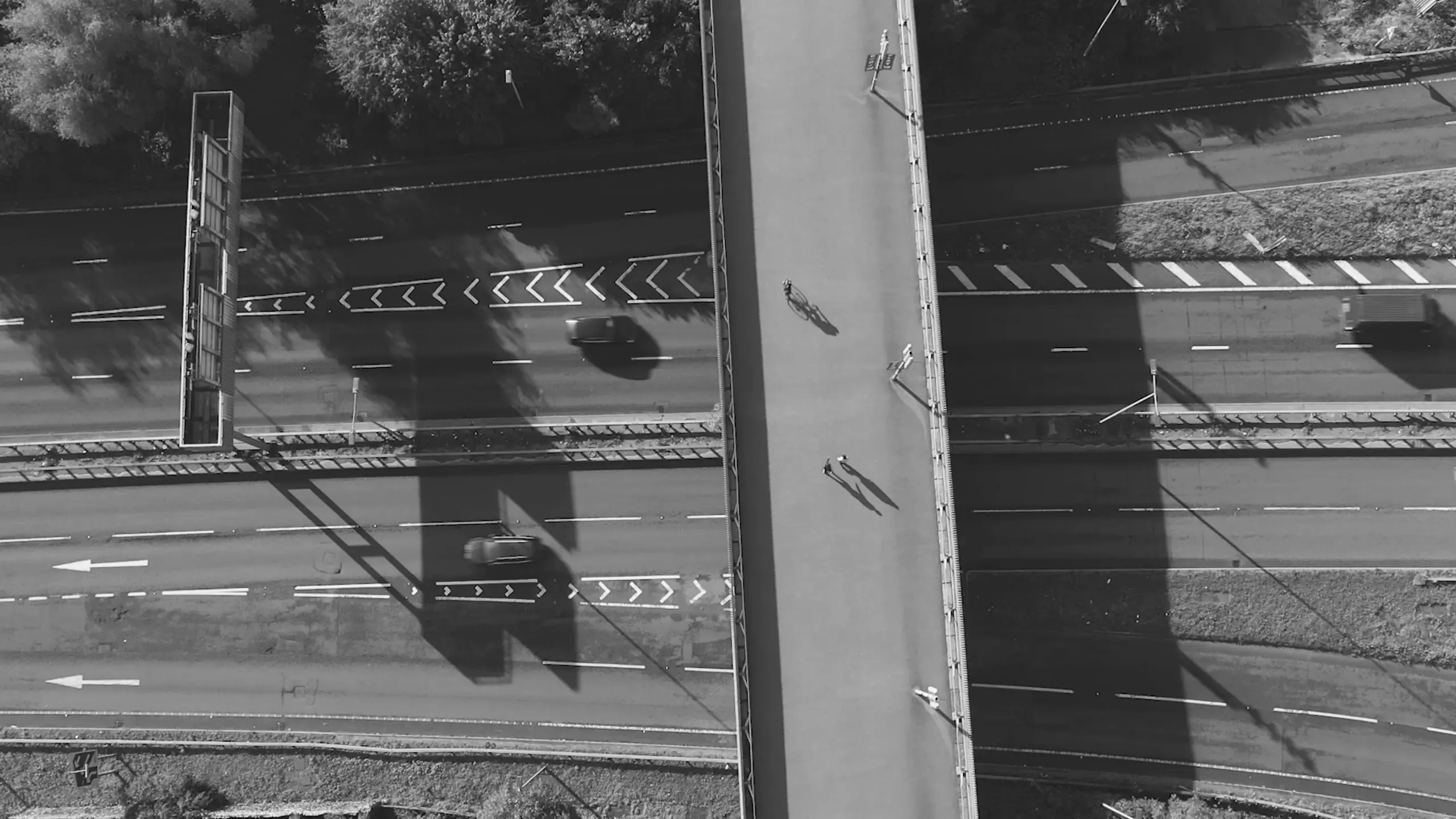 Top-down drone perspective of a footbridge over the A12